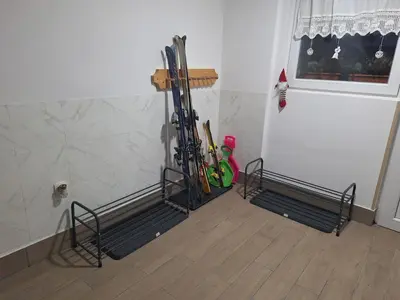 a room with a bunch of skis on a wall at Apartma Bogi Kranjska Gora in Kranjska Gora