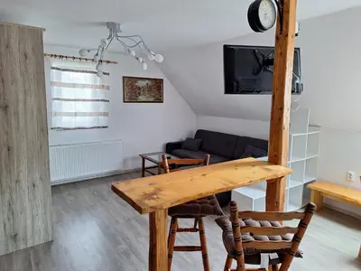 a living room with a table and a couch at Apartma Bogi Kranjska Gora in Kranjska Gora