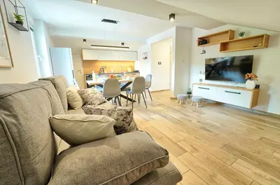a living room with a couch and a dining room at Apartments Lipa Plac in Postojna