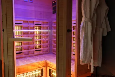 a walk in shower with purple lighting in a room at Apartments Lipa Plac in Postojna