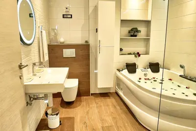 a bathroom with a tub and a sink and a toilet at Apartments Lipa Plac in Postojna