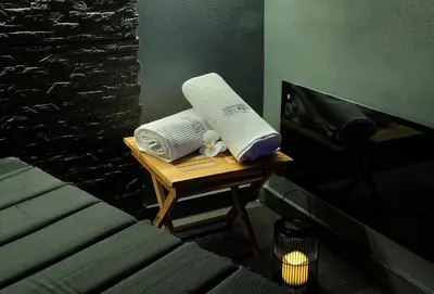 two towels sitting on a table next to a bed at Apartments Lipa Plac in Postojna