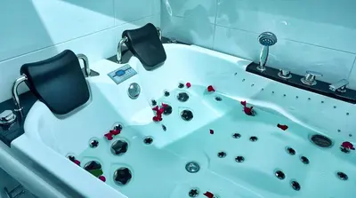 a bathroom with a tub with rocks in it at Apartments Lipa Plac in Postojna