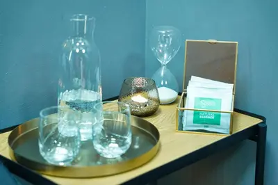 a table with a glass vase and other items on it at Apartments Lipa Plac in Postojna