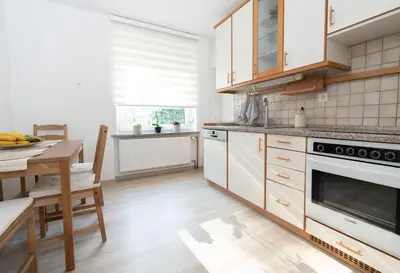 a kitchen with a table and a stove top oven at Apartments BUMM in Ljubljana