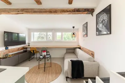 a living room with a couch and a table at Studio Nensi in Ljubljana
