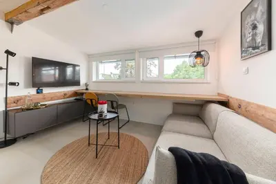 a living room with a couch and a table at Studio Nensi in Ljubljana