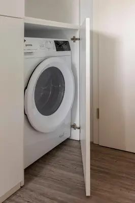 a washing machine in a room with a door at Tiny House Ljubljana in Ljubljana