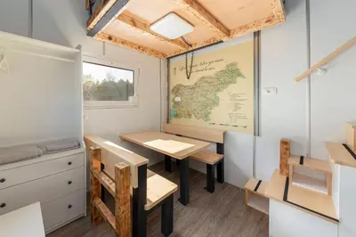 a room with a table and a map on the wall at Tiny House Ljubljana in Ljubljana