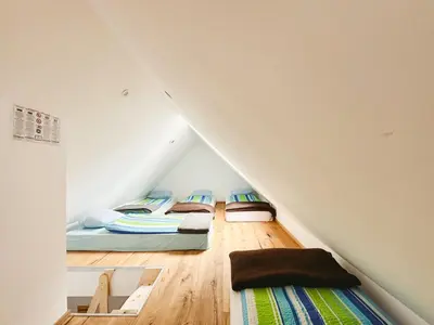 a room with two beds in a attic at Koča ob izviru Soče in Trenta