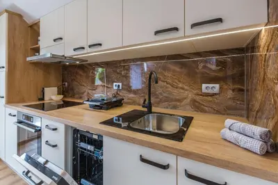 a kitchen with a sink and a counter at Apartma Bistr'ca in Bohinj