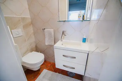 a bathroom with a toilet and a sink at Holiday Home Slavc with 4 Bedrooms in Brežice