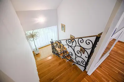 a staircase with a vase of flowers in a room at Holiday Home Slavc with 4 Bedrooms in Brežice