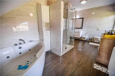 a bathroom with a tub and a shower and a toilet at Holiday Home Slavc with 4 Bedrooms in Brežice