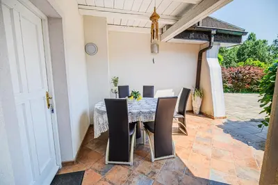 a patio with a table and chairs on a patio at Holiday Home Slavc with 4 Bedrooms in Brežice
