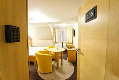a room with a bed and a table and a door at Vila Sofia in Tržič