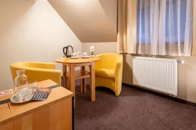 a room with a table and yellow chairs and a table and a tablektop at Vila Sofia in Tržič