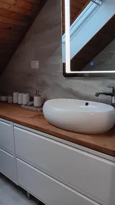 a bathroom with a white sink and a mirror at Hiša Piber in Bled
