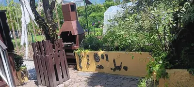 a garden with a fence and a planter with plants at Hiša Piber in Bled