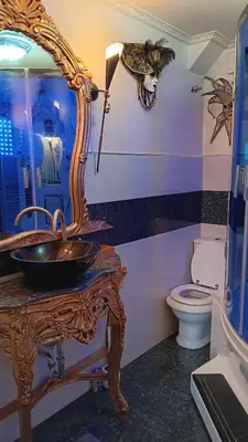 a bathroom with a sink and a mirror on a table at Hiša Piber in Bled