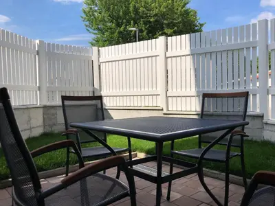 a black table and chairs in front of a fence at Lavender in Postojna