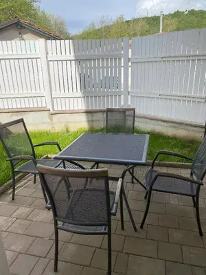 a picnic table and two chairs on a patio at Lavender in Postojna