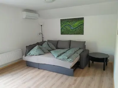 a living room with a couch and a table at Apartments Field Flower in Radovljica