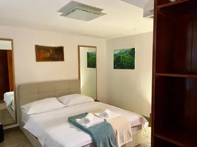 a bedroom with a bed with towels on it at Grand Cesar Bled in Bled