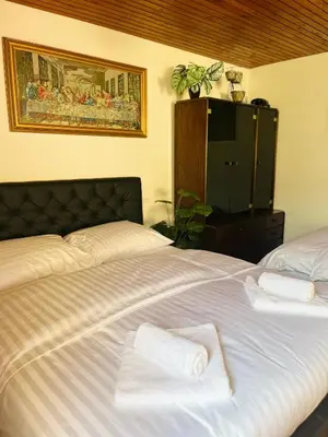 a bedroom with a bed with towels on it at Grand Cesar Bled in Bled