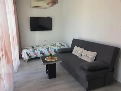 a living room with a couch and a table at Mediteran Apartments in Koper
