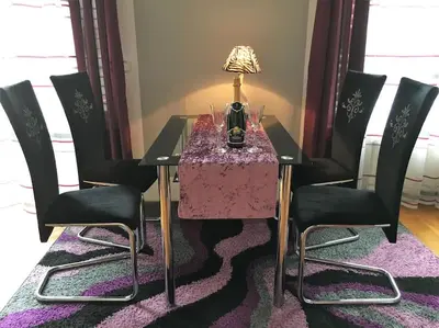 a dining room table with chairs and a lamp on it at Stylish Boutique Apartment in Ljubljana