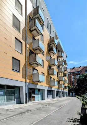 a building with balconies on the side of a street at Stylish Boutique Apartment in Ljubljana