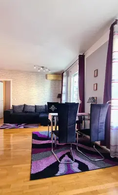 a living room with a couch and a table at Stylish Boutique Apartment in Ljubljana