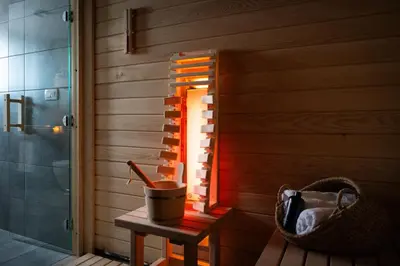 a room with a sauna with a bucket on a table at Johanca in Obrov