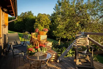 a deck with a table with flowers on it at Johanca in Obrov