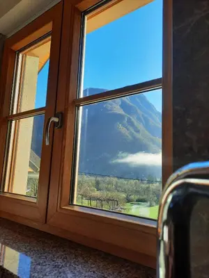 a window with a view of a mountain at Hiša Ella in Žaga
