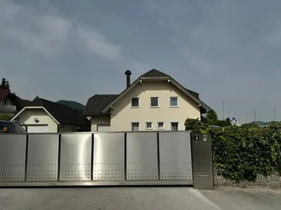 a white fence in front of a house at Apartment Šentjur center in Šentjur