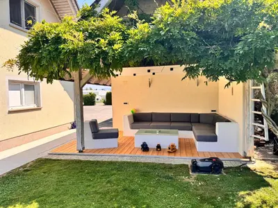a living room with a couch and a tree at Apartment Šentjur center in Šentjur