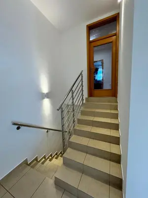 a staircase in a building with a door and a window at Apartment Šentjur center in Šentjur
