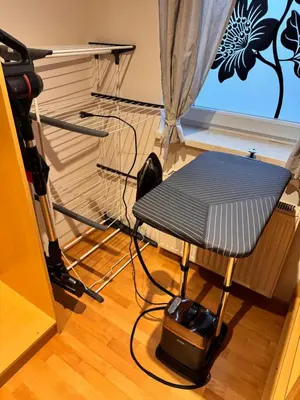 a room with a chair in front of a window at Apartment Šentjur center in Šentjur