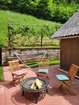 three chairs and a fire pit on a patio at Apartma in wellness Mesečina in Libeliče