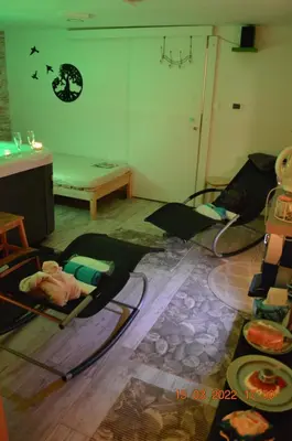 a room with several beds on the floor and a table at Apartma in wellness Mesečina in Libeliče