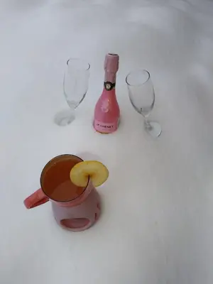 a cup of coffee and wine glasses on a table at Apartma in wellness Mesečina in Libeliče