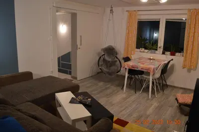 a living room with a couch and a table at Apartma in wellness Mesečina in Libeliče