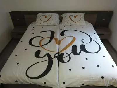 a bed with the word love written on it at Apartma in wellness Mesečina in Libeliče