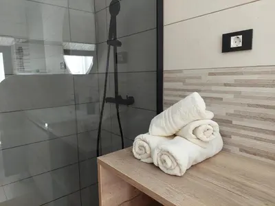 a pile of towels sitting on a table in a bathroom at Studio apartment Under the castle in Škofja Loka