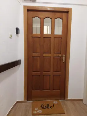 a wooden door with a welcome mat in front of it at Studio apartment Under the castle in Škofja Loka