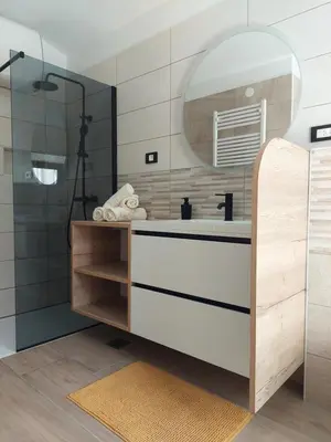 a bathroom with a sink and a mirror at Studio apartment Under the castle in Škofja Loka