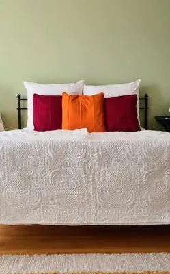 a white bed with four pillows on top of it at Heaven Can Wait Country Retreat in Poljane nad Škofjo Loko