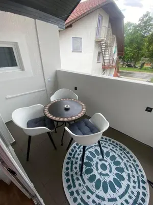 a balcony with a table and two chairs and a window at Apartma Špela in Slivnica pri Mariboru
